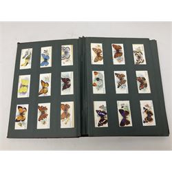 Early 20th century ephemera, to include signed photographs of Charles Boyer and Walter Pidgeon etc, a printed letter from Winston Churchill, two albums and a quantity of transfer books of Players and similar cigarette cards, including Boy Scout and Girl Guide Patrol Signs and Emblems and RAF Badges, a collection of greetings cards and postcards, a photograph album containing black and white photographs of Caius College Cambridge and guides and pamphlets on travelling Switzerland and the UK