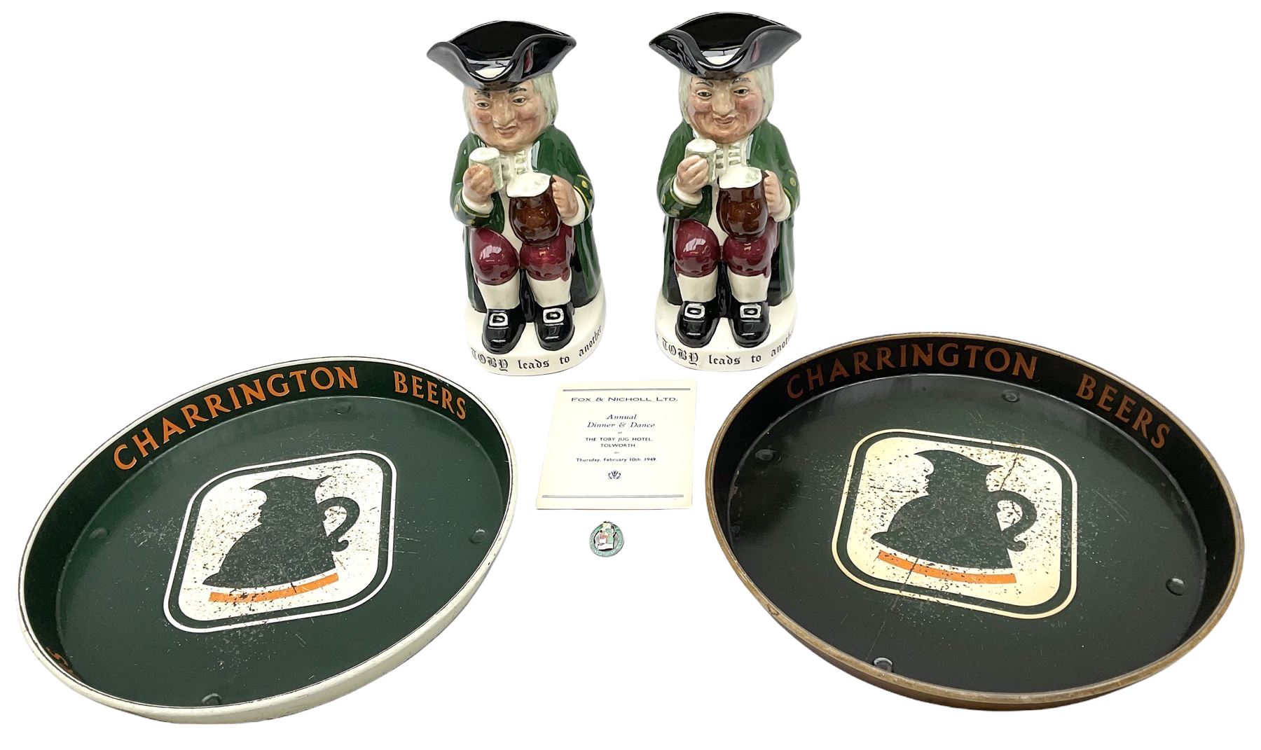 Pair of Royal Doulton Toby Ale Jugs, produced in 1934 for Charrington Ales, together with two circular metal serving trays advertising Charrington brewery, a Charrington badge awarded for 25 years of service and a 1949 menu Fox & Nicholl Ltd annual dinner dance at the toby jug hotel.  