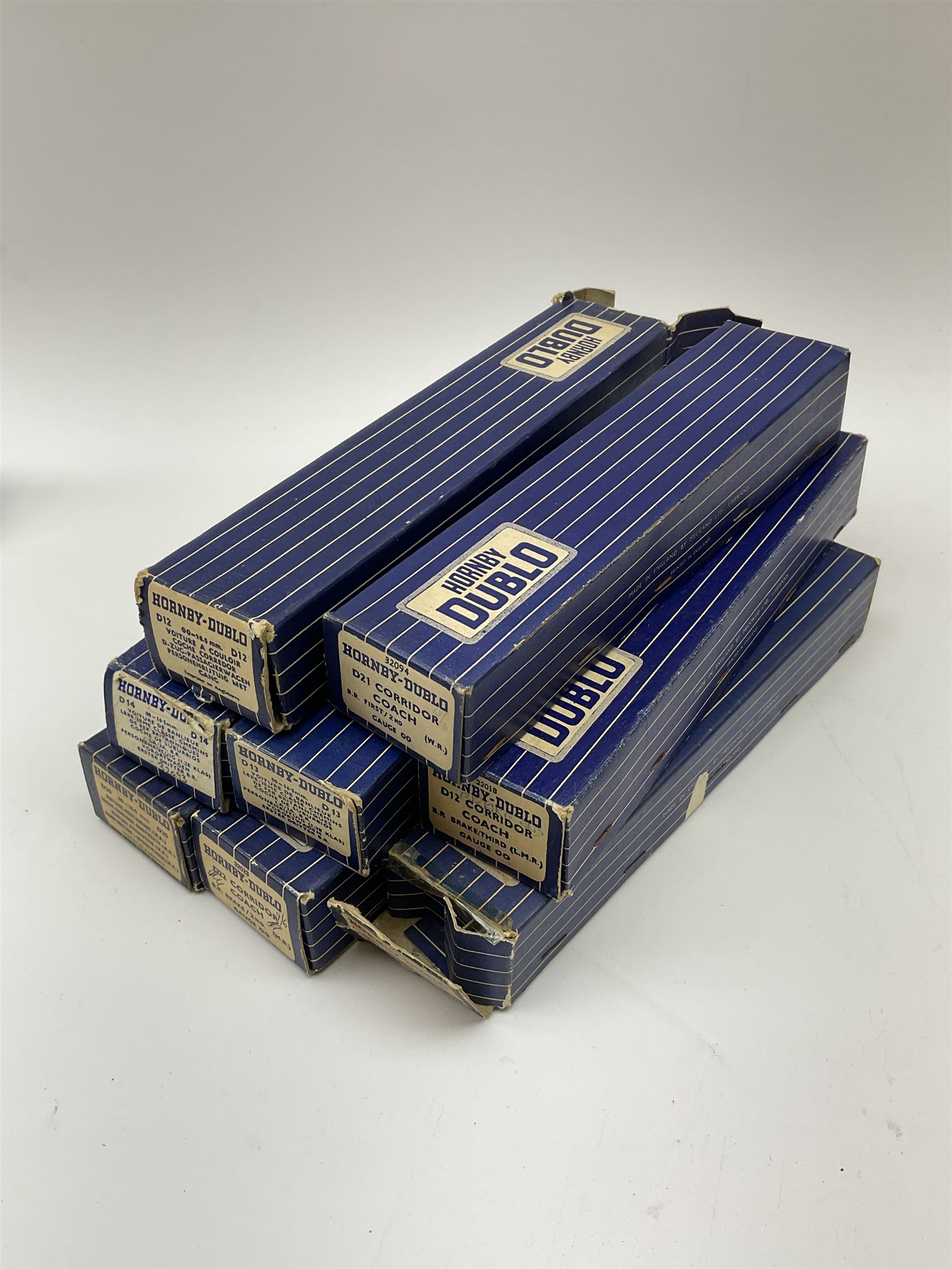 Hornby Dublo - eight coaches comprising D12 First L.M.S.; 32018 D12 Corridor Coach B.R. Brake/3rd (L.M.R.); 32090 D13 Suburban Coach First/Third B.R.; 32093 D14 Suburban Coach Brake/Third B.R.; 32096 D20 Composite Restaurant Car (Western Region); two 32094 D21 Corridor Coach B.R. First/2nd (W.R.); and 32023 D22 Corridor Coach B.R. Brake/2nd (M.R.); all in boxes (8)
