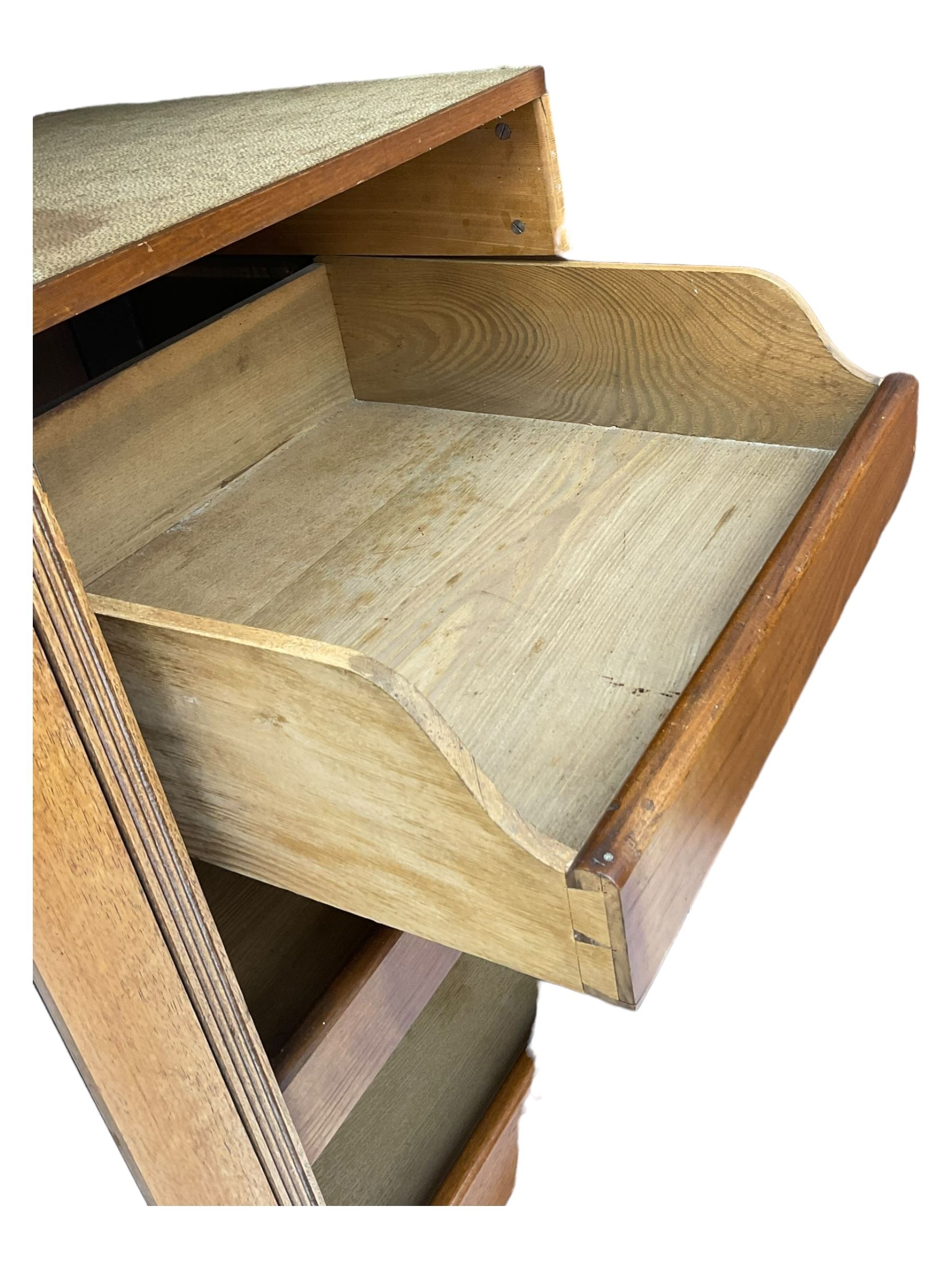 Late Victorian walnut triple combination wardrobe, projecting moulded and dentil cornice, central shaped bevelled mirror glazed door, cartouche and curled leaf carved panels over figured walnut veneered panels, fitted with drawer to base, on bracket feet