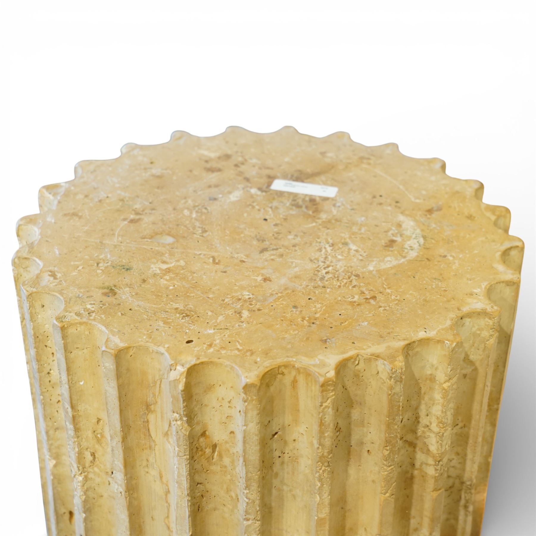 A pair of early 20th century Italian Neoclassical pedestal columns of simplified Doric type; each of fluted cylindrical form in composite stone, finished to evoke weathered limestone or travertine, raised on square plinth bases