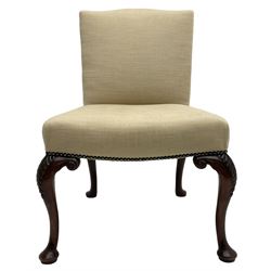 Early 20th century Chippendale design mahogany chair, shaped cresting rail upholstered in pale fabric with a studded bands, on cabriole supports, the front supports carved with foliage and bell flowers