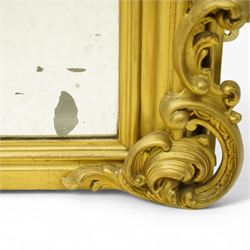 19th century Rococo Revival large gilt framed mirror, with bevelled rounded rectangular plate enclosed by a carved giltwood frame, surmounted by pierced scroll and foliate cresting, floral and scroll details to sides and corners