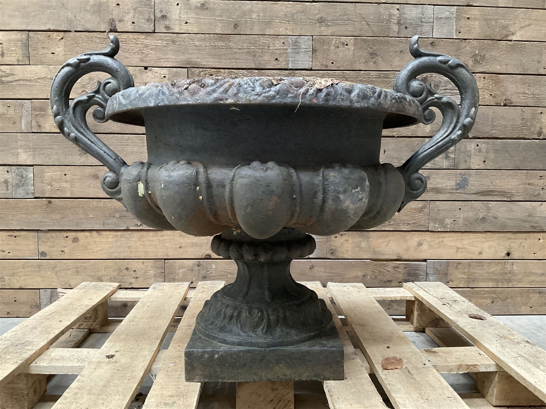 Victorian design ornate cast iron centrepiece urn, featuring two handles, raised on footed base