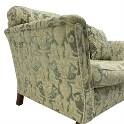 Pair of Edwardian design two-seat sofas, upholstered in urn and curled acanthus leaf patterned fabric, on turned feet with brass cups and castors 