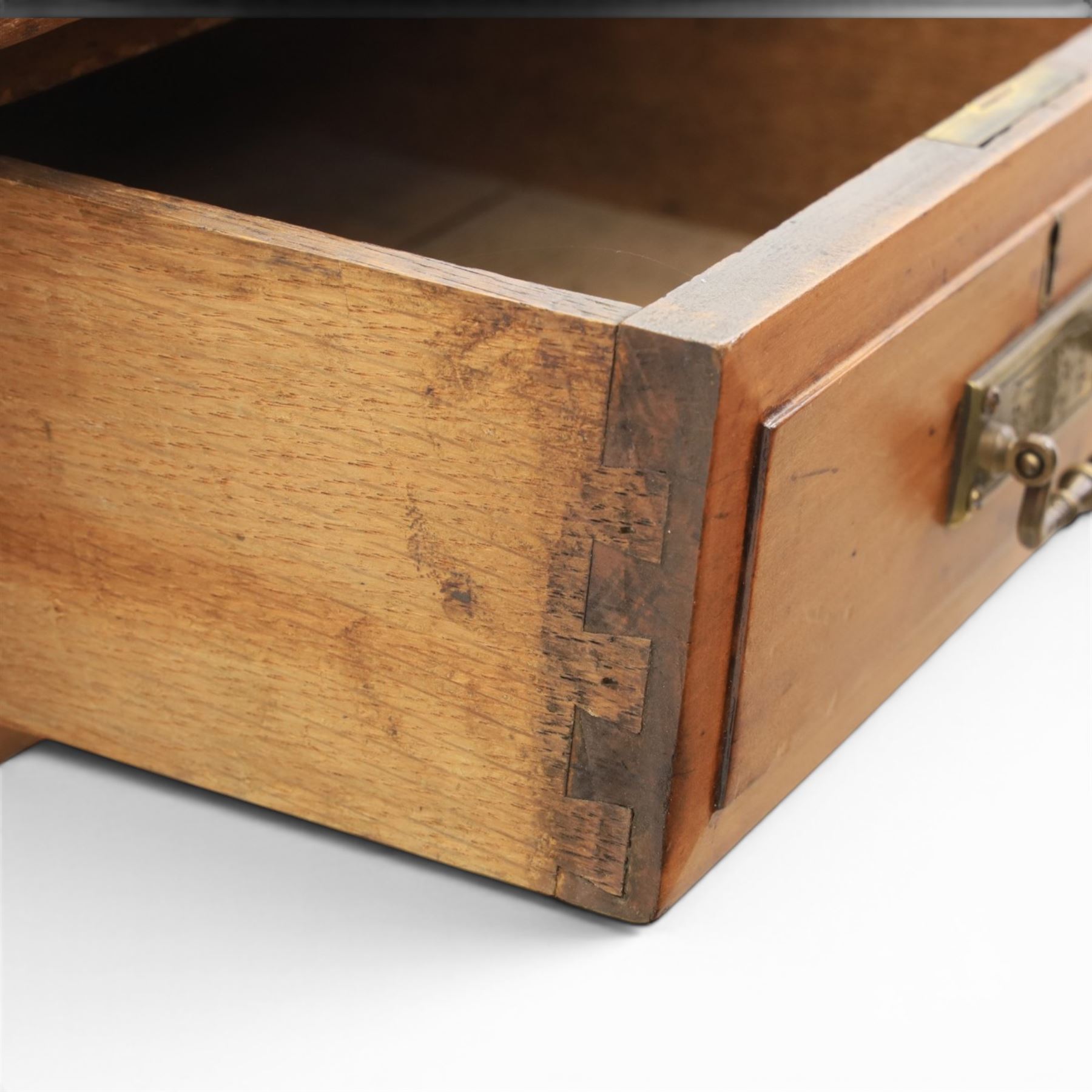 Victorian pitch pine writing table with leather inset top, rectangular top with three frieze drawers, pierced brass handles, raised on turned and fluted supports terminating in castors