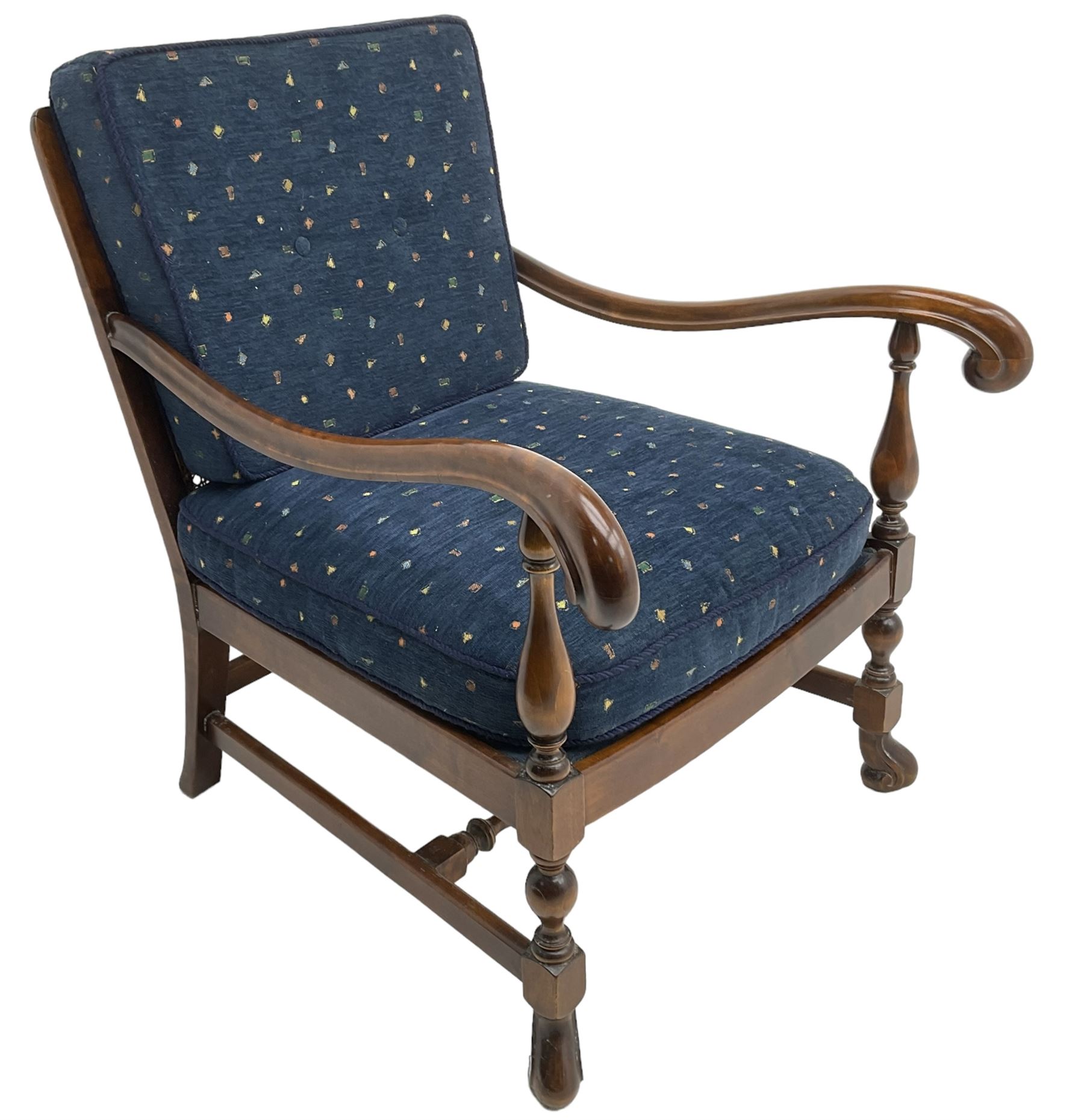 Early 20th century stained beech framed armchair, cane panel back over scrolled arm terminals, raised on turned supports united by turned H-stretcher, with patterned blue upholstered loose back and seat cushions