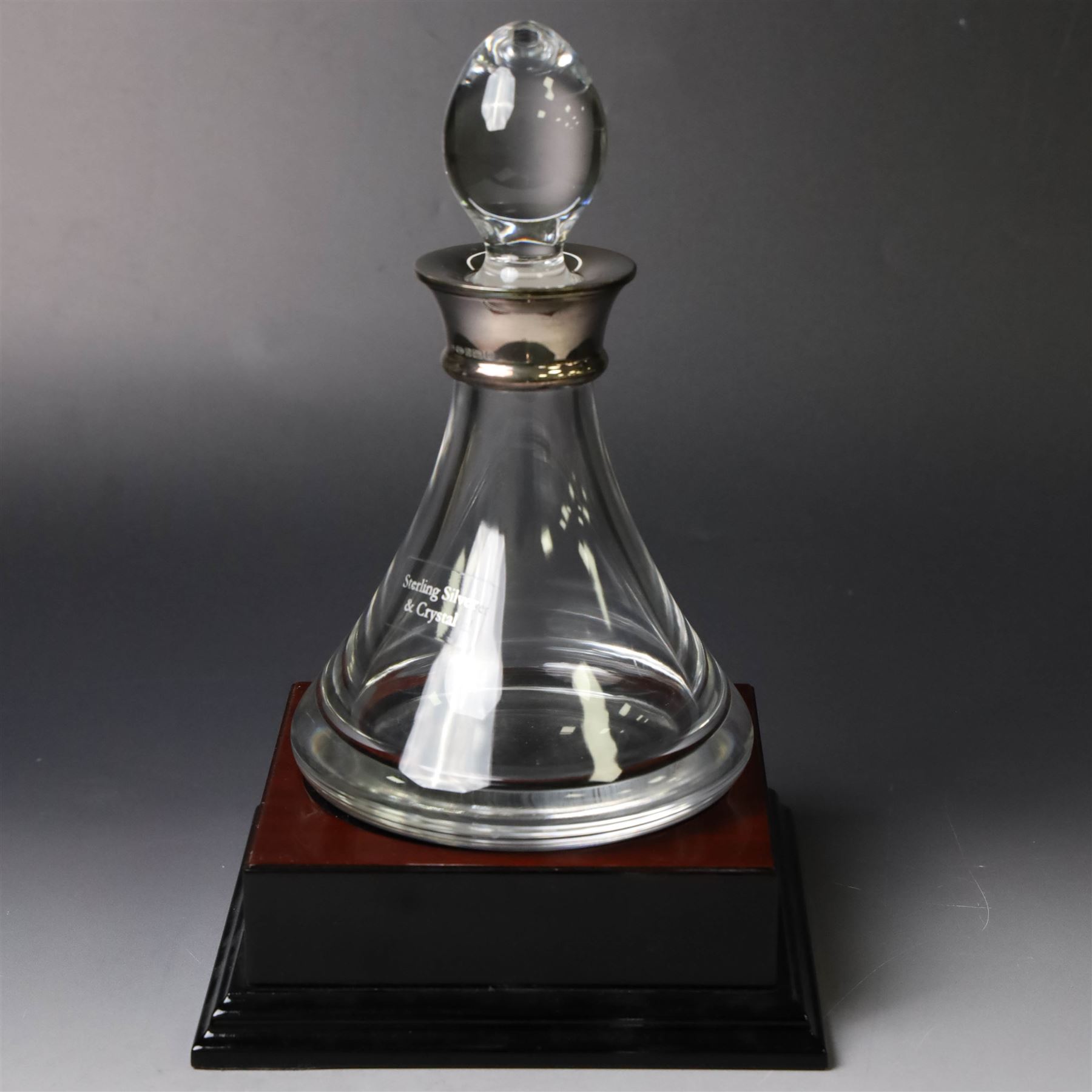 Silver mounted glass decanter, boxed with wooden plinth, together with a silver pepper grinder and a silver mounted Carrs desk clock, all hallmarked
