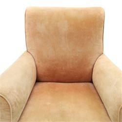 Victorian mahogany framed armchair of traditional shape, the high sprung rolled back over out-swept arms, deep sprung seat over turned feet with ceramic castors, upholstered in pale salmon pink fabric