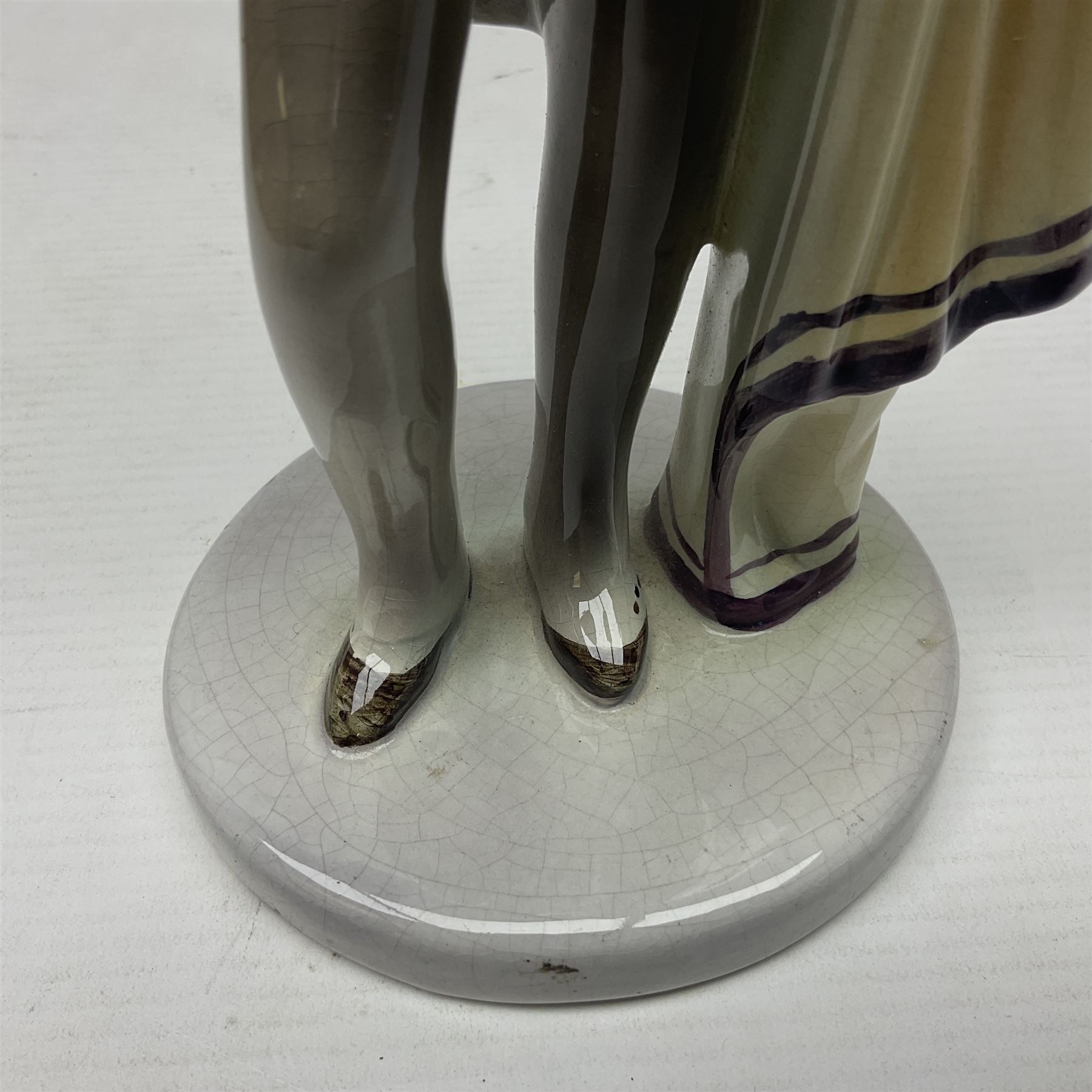 Goldscheider figure, modeled as a gentleman with flowers, upon a circular base, with printed mark beneath, H25cm