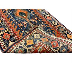 Persian blue ground rug, field decorated with four pole medallions with surrounding repeating bird motifs, coral spandrels with flowerheads, guarded border decorated with repeating geometric lozenges