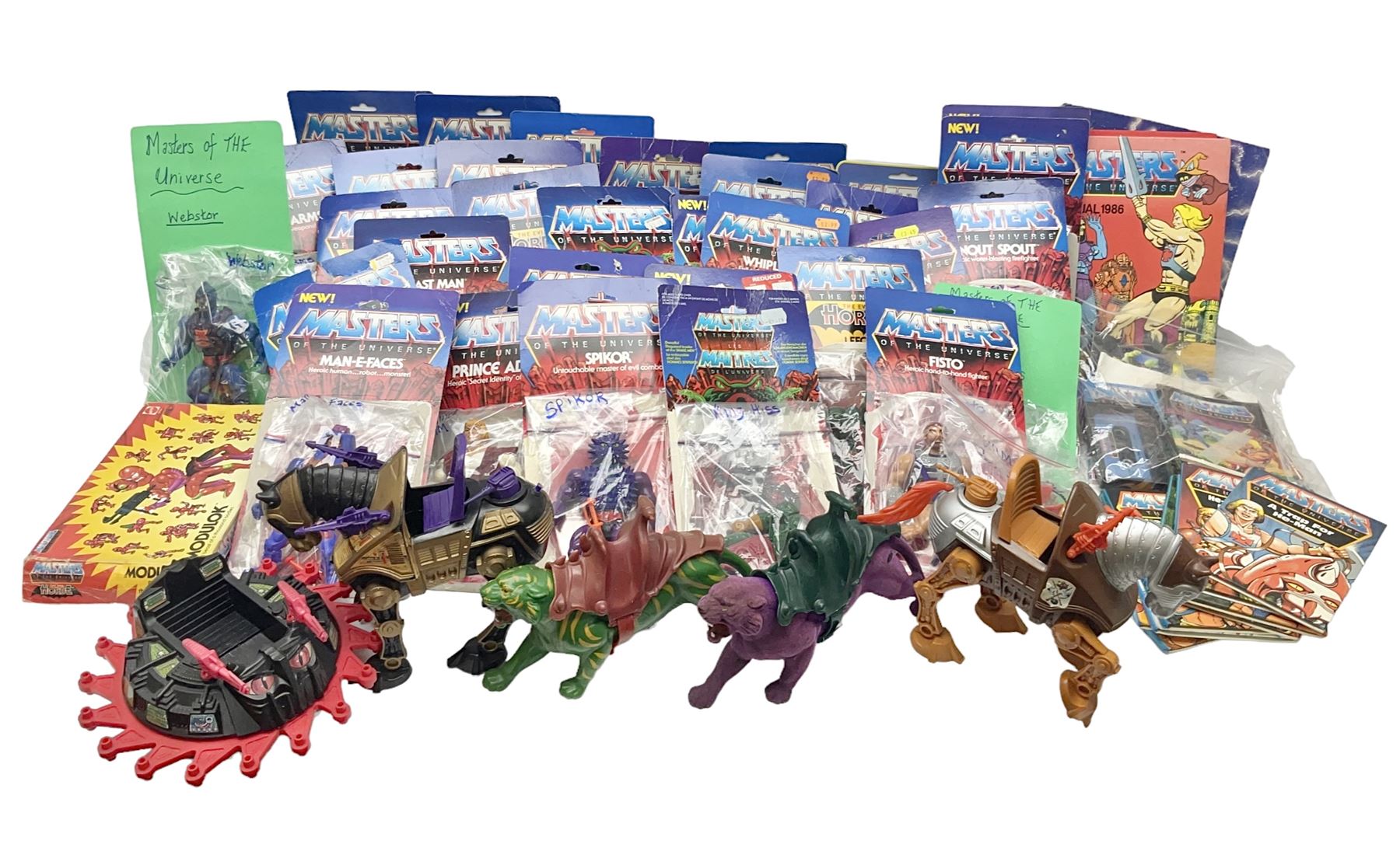 Thirty-one Masters of the Universe He-Man figures re-bagged on original backing cards;  two others lacking backing cards; boxed Modulok figure; bag of weapons and accessories; Roton, two horses and two battle cats; 1986 & 1987 Annuals; Ladybird and other story books; Panini sticker album; instructions etc