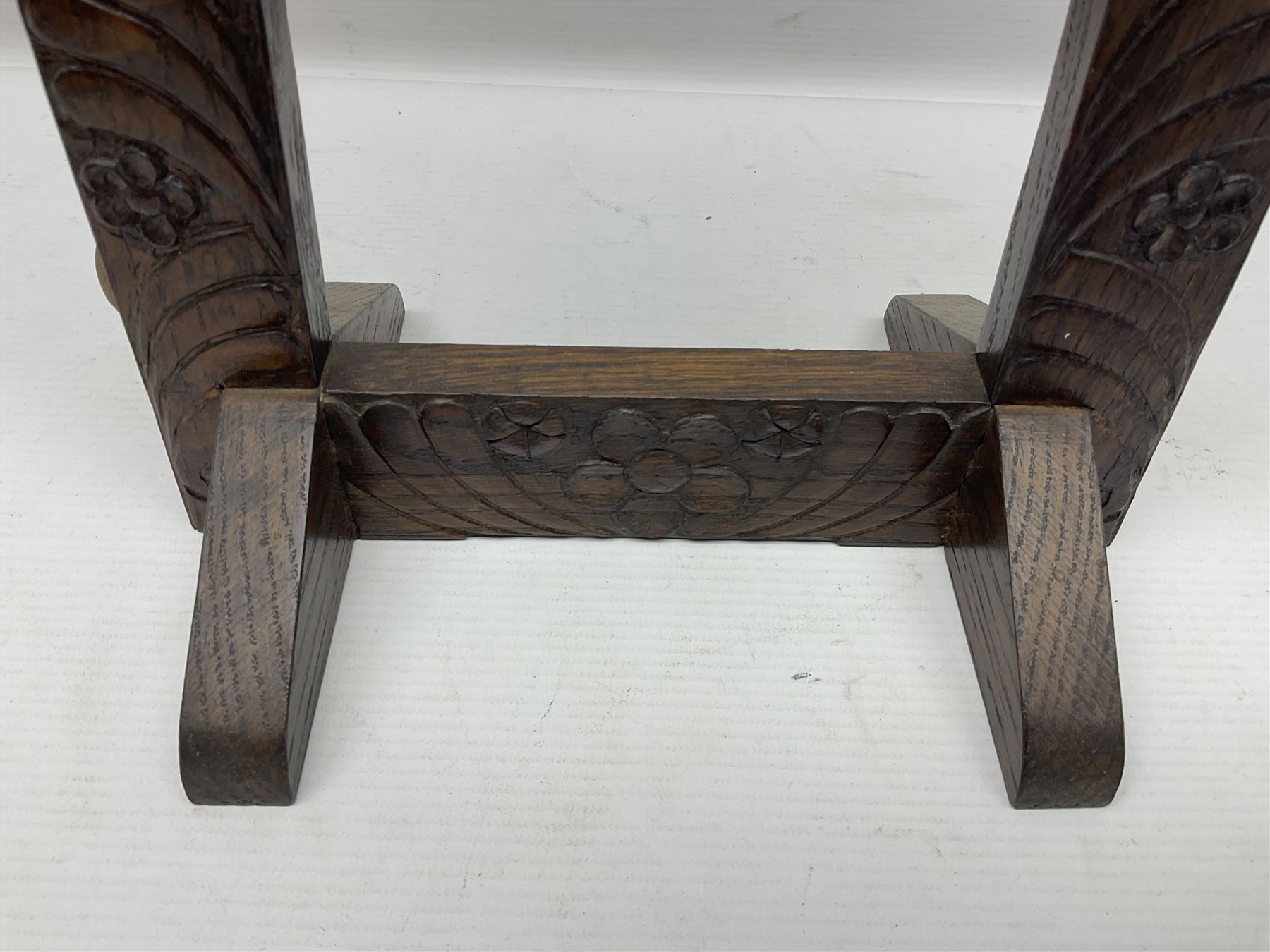 Chinese brass temple bell, decorated in high relief with a a dragon chasing a flaming pearl, within a carved floral hardwood stand, H36cm