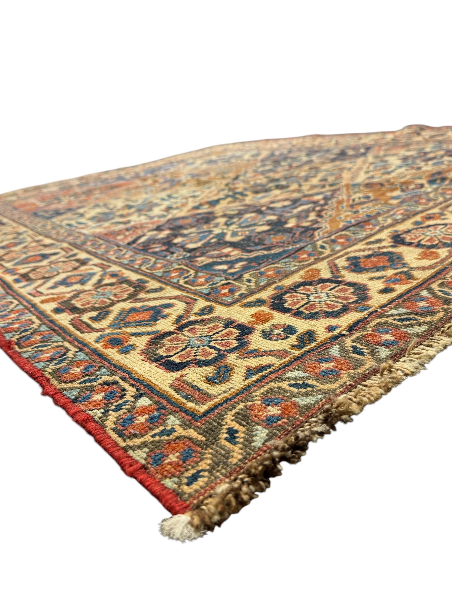Caucasian pale ground rug, the field divided into lozenges each decorated with stylised plant motifs, the guarded border decorated with repeating flower heads 