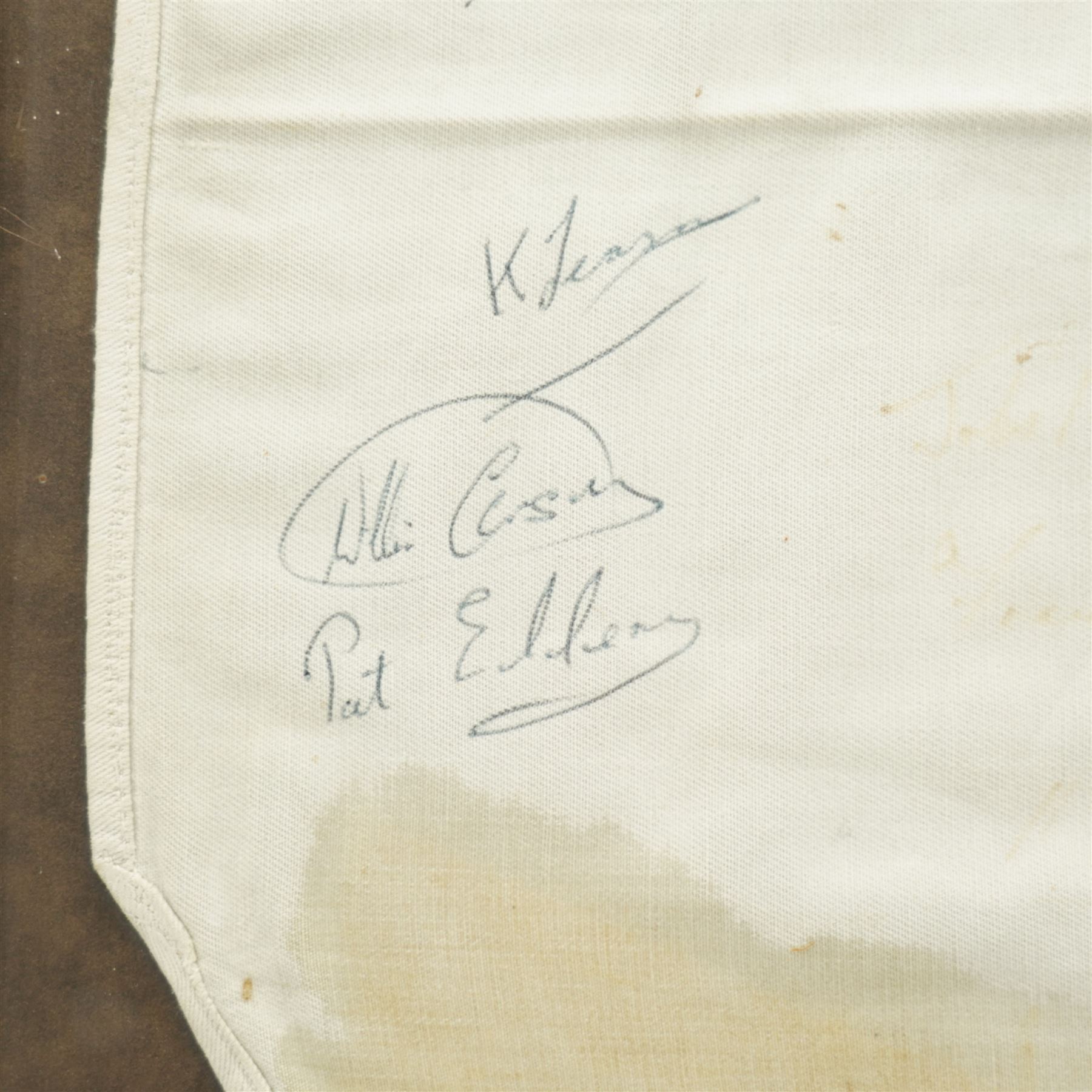 Signed saddle cloth, previously on display in the Mount Royale Hotel, York, autographed by various visiting jockeys and racing related television persons, to include Pat Eddery, Brough Scott, John McCririck, Peter O Sullivan, Willie Carson and others, frame 85cm x 69cm 