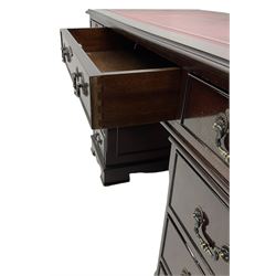 Georgian design mahogany twin pedestal desk, the top with inset red oxblood leather writing surface, fitted with nine cock-beaded and graduating drawers