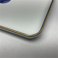 Limoges for Cartier, ceramic trinket dish, of rectangular form with rounded corners, decorated to centre with leopard upon a blue ball, with blue and gilt rim, with printed mark beneath, in original box, H15.5cm, W21cm