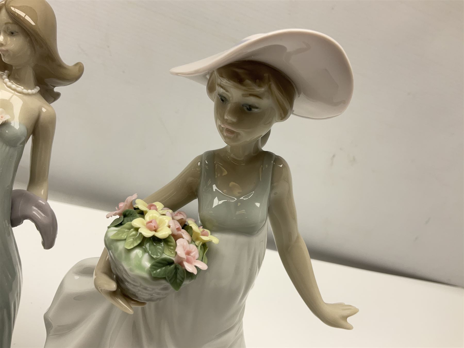 Three Lladro figures of ladies comprising 'The Flirt' model no 5789, 'Ingenue' model no 5487 and 'Carefree' model no 5790, all with boxes