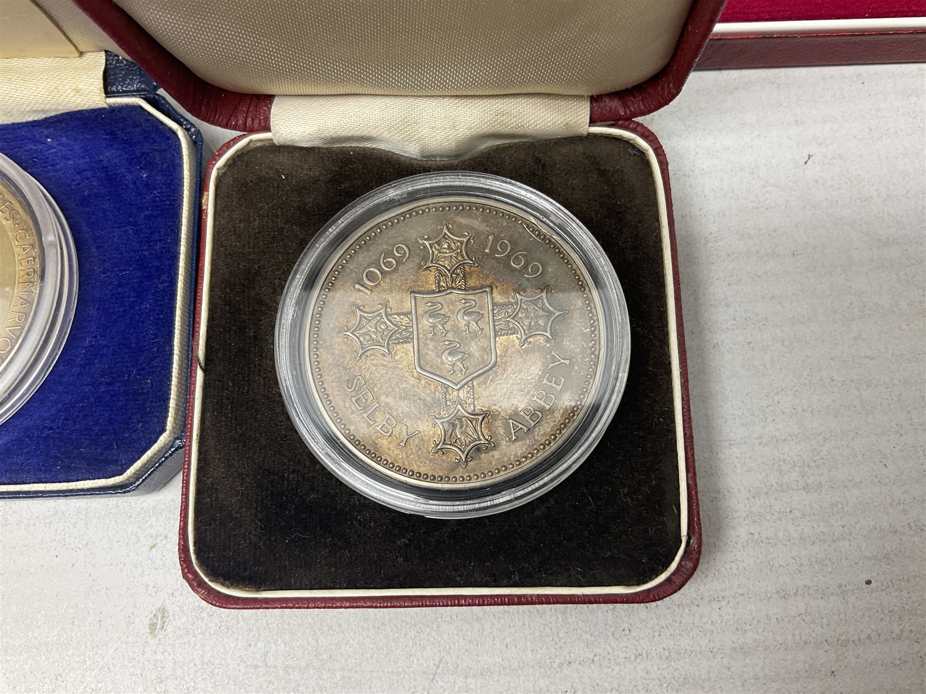 Commemorative coins and medallions, including hallmarked silver poultry medal, Royal Mint 'College of Arms Quincentenary Commemorative Medal', Selby Abbey '1069 1969' medallion, two medallions commemorating the Investiture of H.R.H. Prince Charles 1st July 1969 and a set of four coins commemorating the Investiture of Prince Charles, all cased 