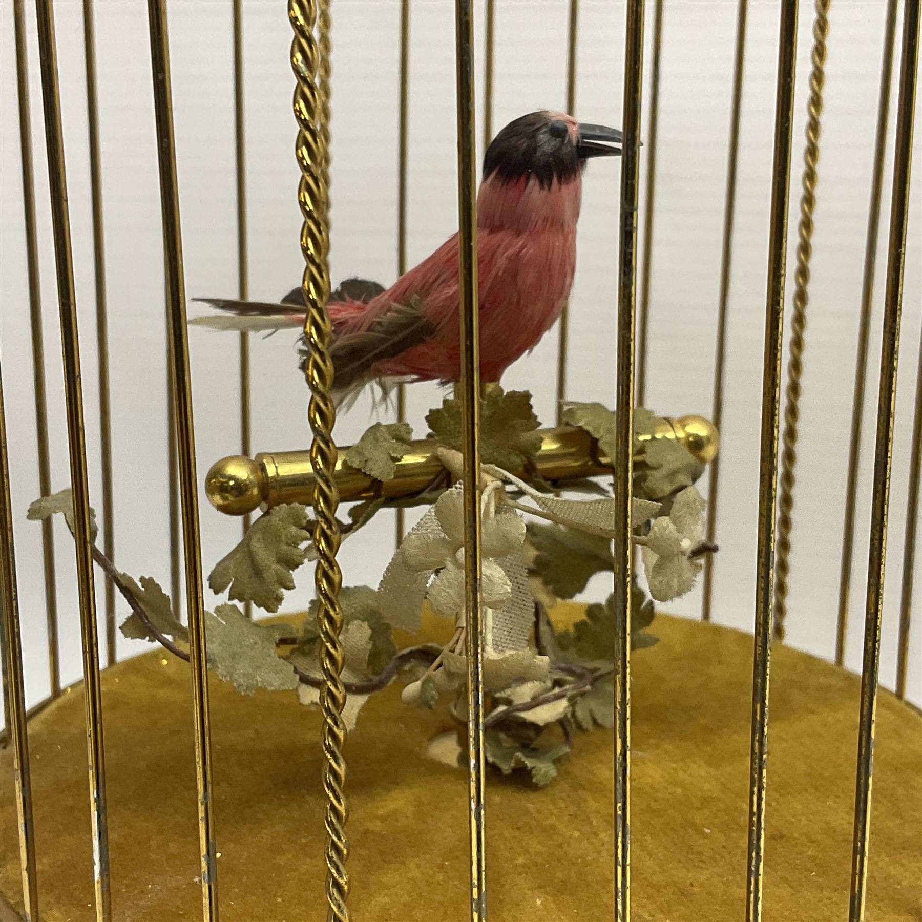 Swiss Reuge Music bird cage automaton music box, the bird with articulated head and beak, in a gilt brass cage, with a glass dome and stand, H30cm