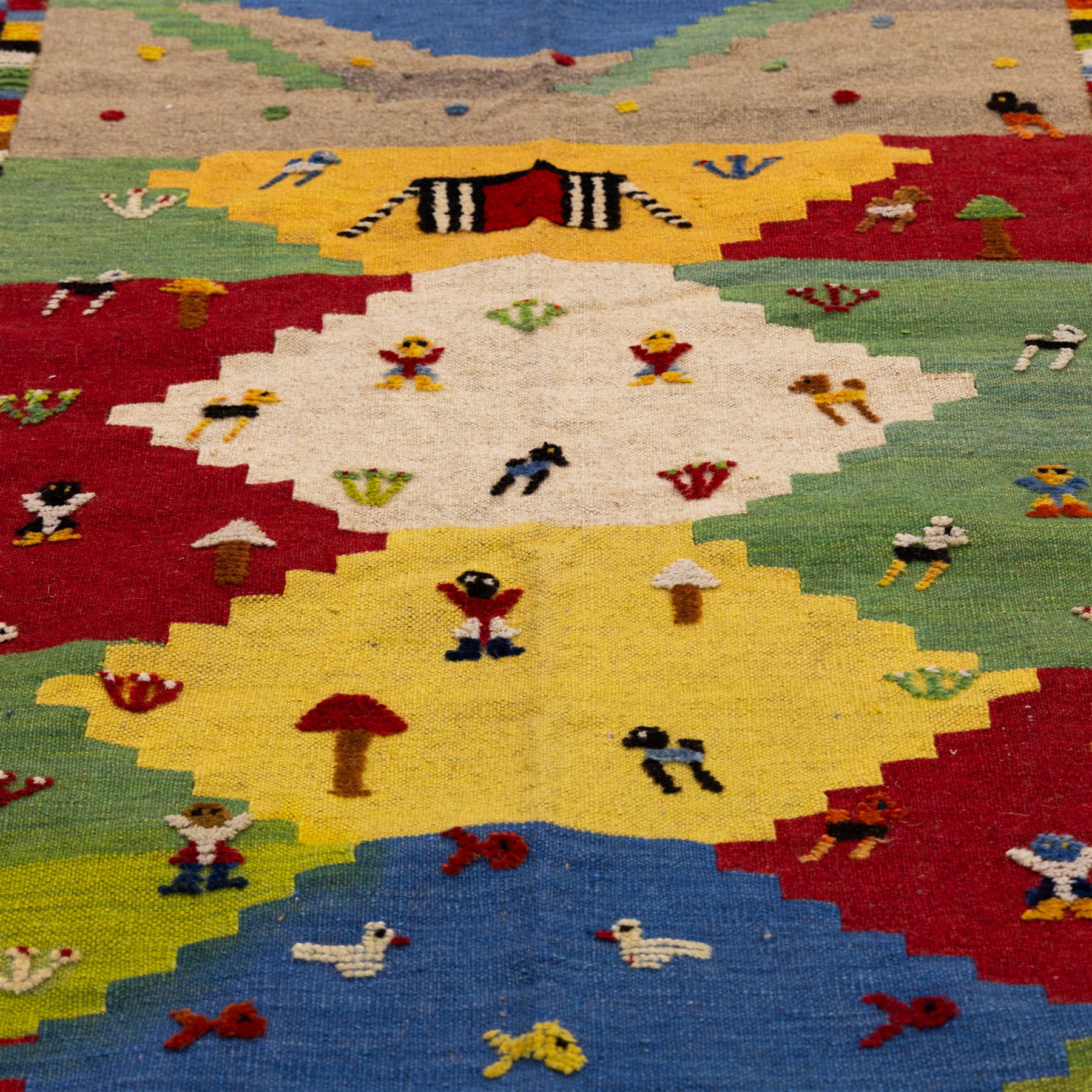 South West Persian Qashqai pictorial flatweave kilim, polychrome field divided into stepped geometric panels decorated with stylized animals, bird, fish and tree motifs with a central ivory lozenge medallion beneath a simple landscape panel with tent motif, figures and and narrow multi-coloured border applied in raised wool pile against a flat-woven ground, fringe ends  