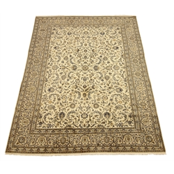  Persian Kashan carpet, ivory ground with blue interlacing overall design, repeating scroll border, decorated with stylised flower heads, 405cm x 311cm  