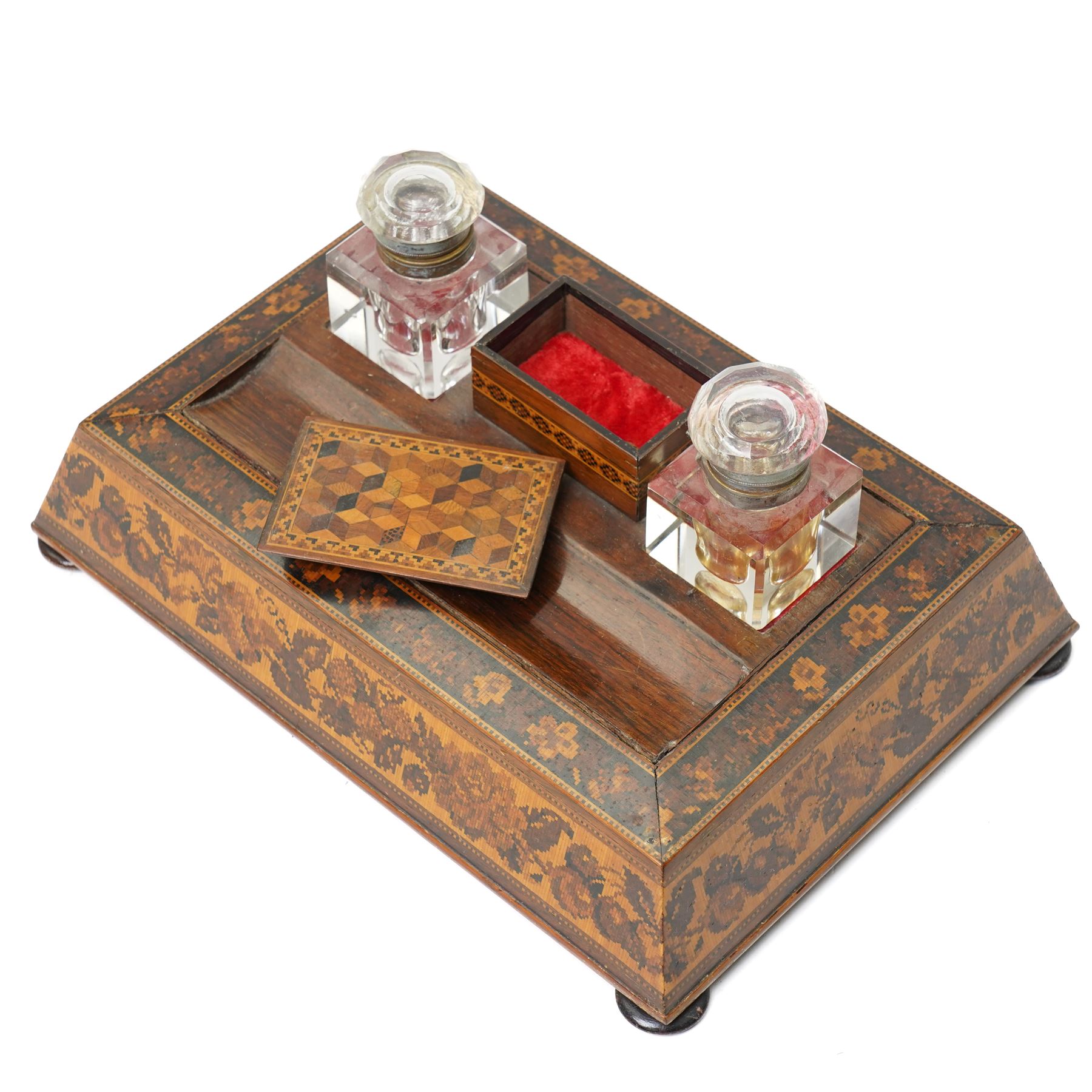 19th century Tunbridgeware inkstand, with two cut glass inkwells, sloping floral mosaic sides, space for pens and covered nib compartment, raised on bun feet, W26cm; together with a pen knife of the same design (2)