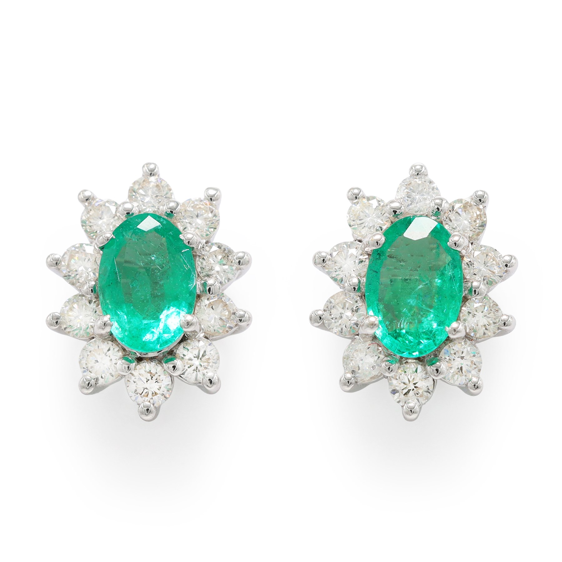 Pair of 18ct white gold emerald and diamond cluster earrings, each stud set with a single oval cut emerald surrounded by round brilliant cut diamonds, stamped, total emerald weight approx 0.75 carat, total diamond weight approx 0.55 carat