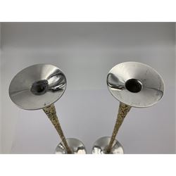 Pair of modern silver candlesticks by Stuart Devlin, the tapering parcel gilt stems with signature textured detailing, each supporting a fluted candle holder and upon a spreading circular foot, hallmarked Stuart Devlin, London 1973, H25cm