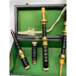  Dummy bagpipes with yellow metal mounted black painted ring turned mahogany drones and Royal Stewart tartan bag, in baize lined carrying case  
