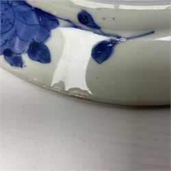 Japanese Meiji period Arita blue and white plate, of circular form, painted with riverside landscape and bird upon flowering branch, with character mark beneath, D24.5cm, together with two 18th century Chinese blue and white plates, each painted with floral design, each approximately D22.5cm