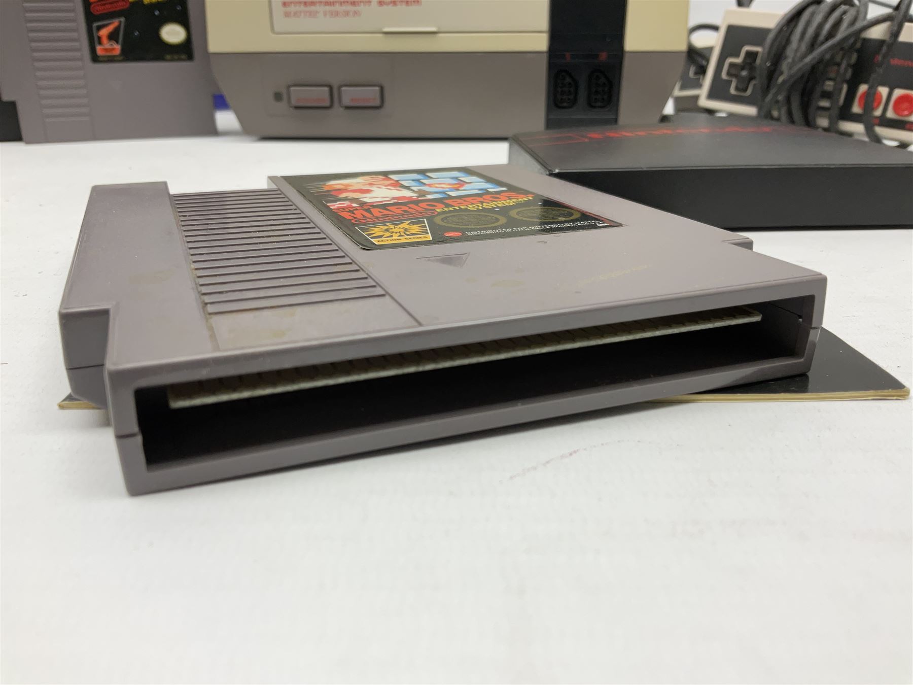 Nintendo Entertainment System (1985) console with two controllers, accessories and instruction booklet. NES Games ‘Duck Hunt’ with Nintendo Zapper gun, ‘Pinball’ and ‘Super Mario Bros.’, all with original sleeves and instruction booklets. NES game ‘Super Mario Bros. 2’ cartridge only