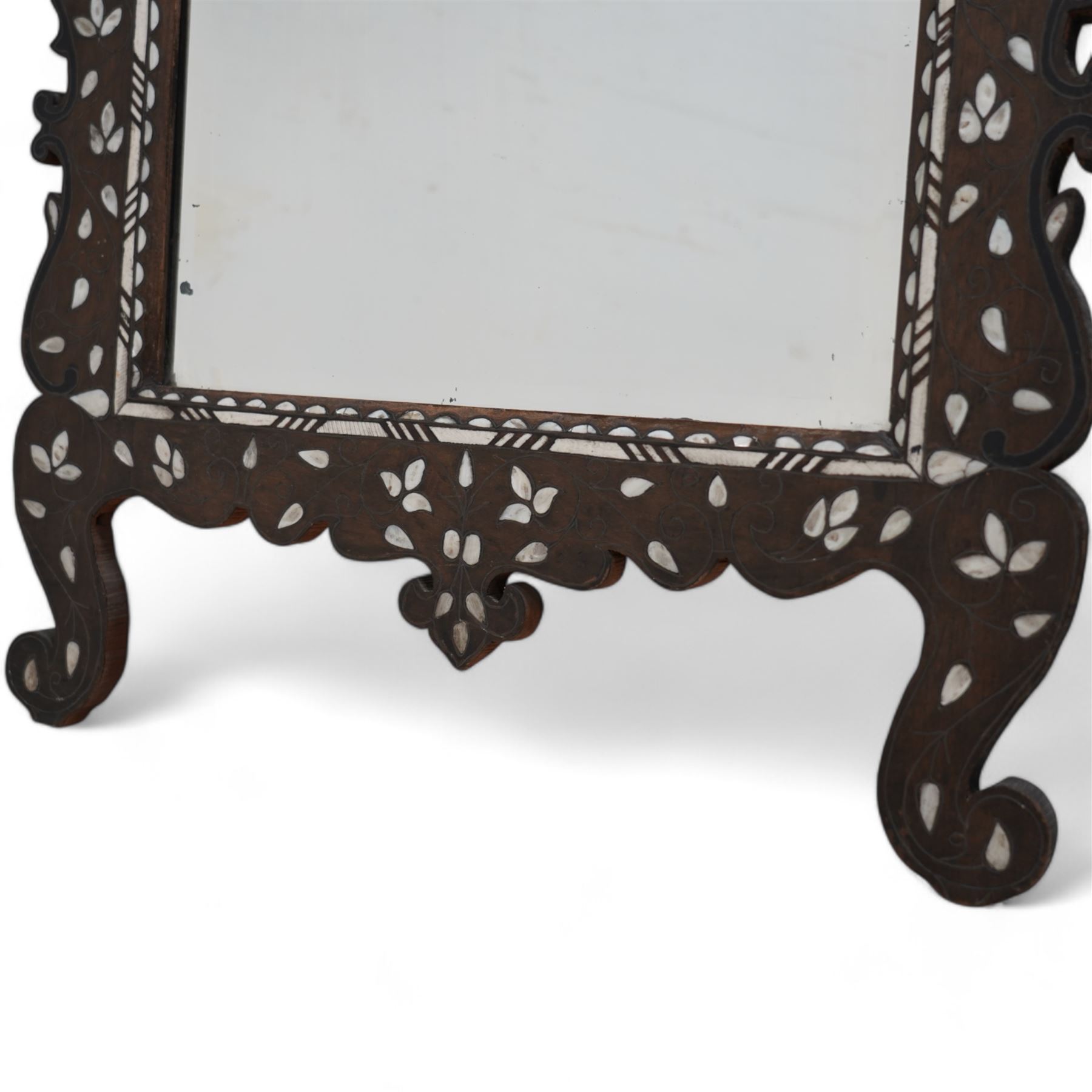 Early 20th century inlaid hardwood Damascus easel mirror, shaped and pierced pediment, inlaid with mother of pearl and carved with trailing foliage, on cabriole feet 