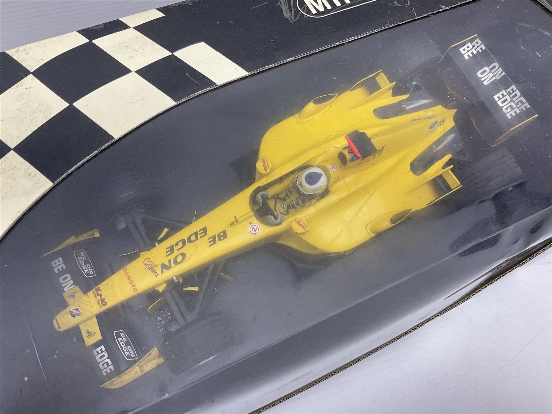 Three Minichamps 1:18 scale die-cast racing cars - Jordan Mugen Honda 198 D. Hill; Jordan Ford EJ13 G. Fisichella; and Stewart Ford SF 1 R. Barrichello; all boxed (3)
