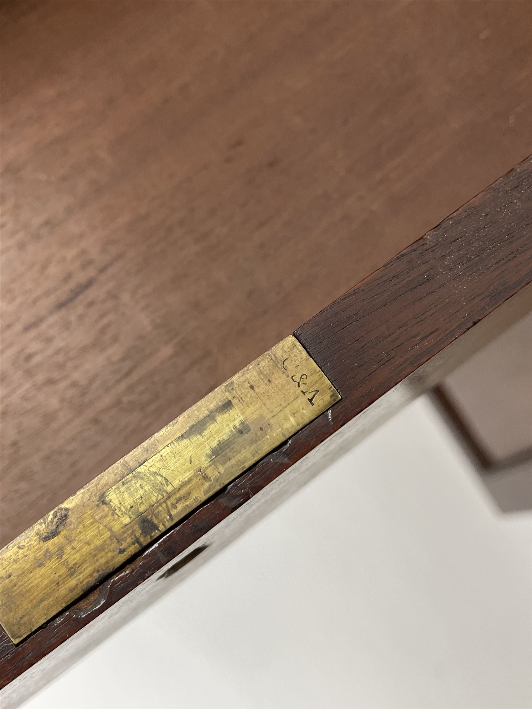 Early Victorian figured mahogany dressing cabinet, the raised shell and scroll carved back lifts to reveal rectangular easel mirror with mahogany band, flat rectangular top with tooled leather inset, slide at each side with matching leather inset, full width drawer above cupboard enclosing a series of five drawers, turned front supports, panelled front, sides and back