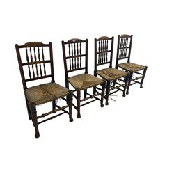 Set four 19th century country elm dining chairs, high back with spindle supports over rush seats, raised on turned supports with pad feet, united by stretchers