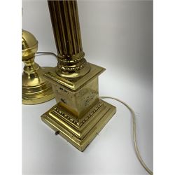 Two brassed table lamps, the first example modelled in the form of a Corinthian column, H53cm, the second example with graduated knopped stem, H53.5cm, together with a pair of light beige fabric shades. 