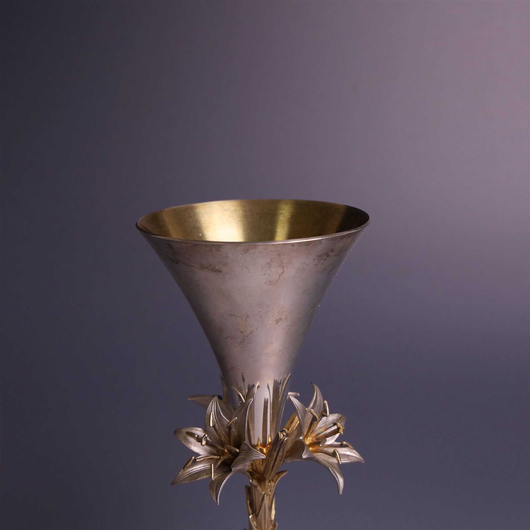 Modern limited edition silver goblet, 'made by order the provost and charter of Blackburn to commemorate the fiftieth anniversary of the cathedral in 1976 and its consecration in 1977' designed by Hector Miller for Aurum, the plain fluted cup, upon a stem of three lillies with parcel gilt highlihts and upon a circular foot, no. 2/750, hallmarked Hector Miller, London 1977, H17cm, boxed with certificate of authenticity