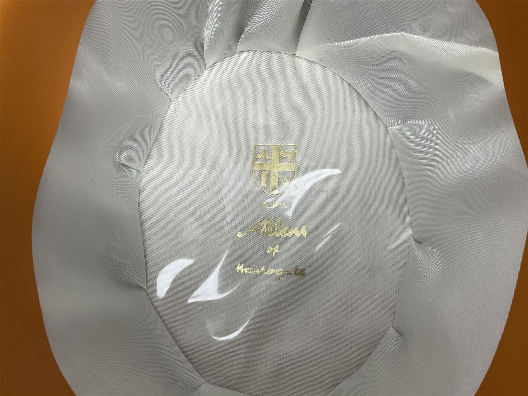 Leather hat box containing black felt top hat with 'British Manufacture' label, together with a grey top hat with 'Allens of Harrogate' label 