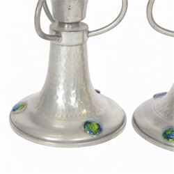 Pair of  Jugendstil hammered pewter candlestick each set with three blue and green enamel roundels, marked Germany beneath, H12cm