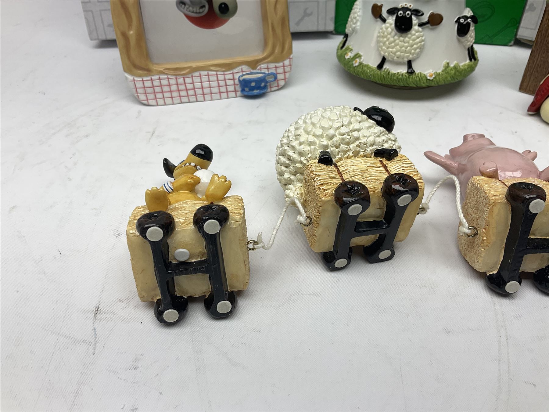 Border Fine Arts Shaun The Sheep Tractor Train and musical figure, together with a Wallace and Gromit photograph frame and a Gromit cruet sett, three in original boxes  