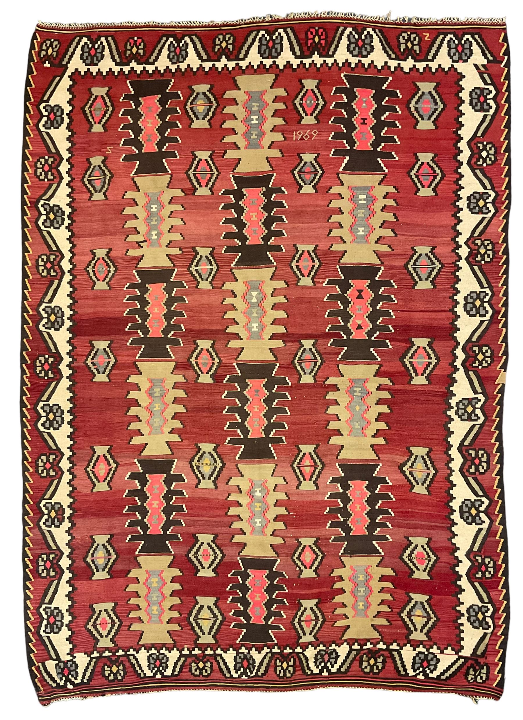 Large  red ground Kilim rug or wall hanging, decorated with geometric patterns and dated within the weave '1969'
