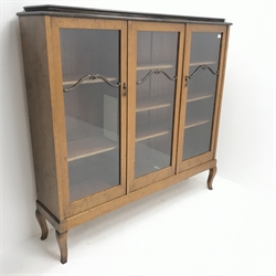 Early 20th century Swedish birch wood triple display bookcase, three glazed doors enclosing two shelves, cabriole feet, W153cm, H147cm, D35cm