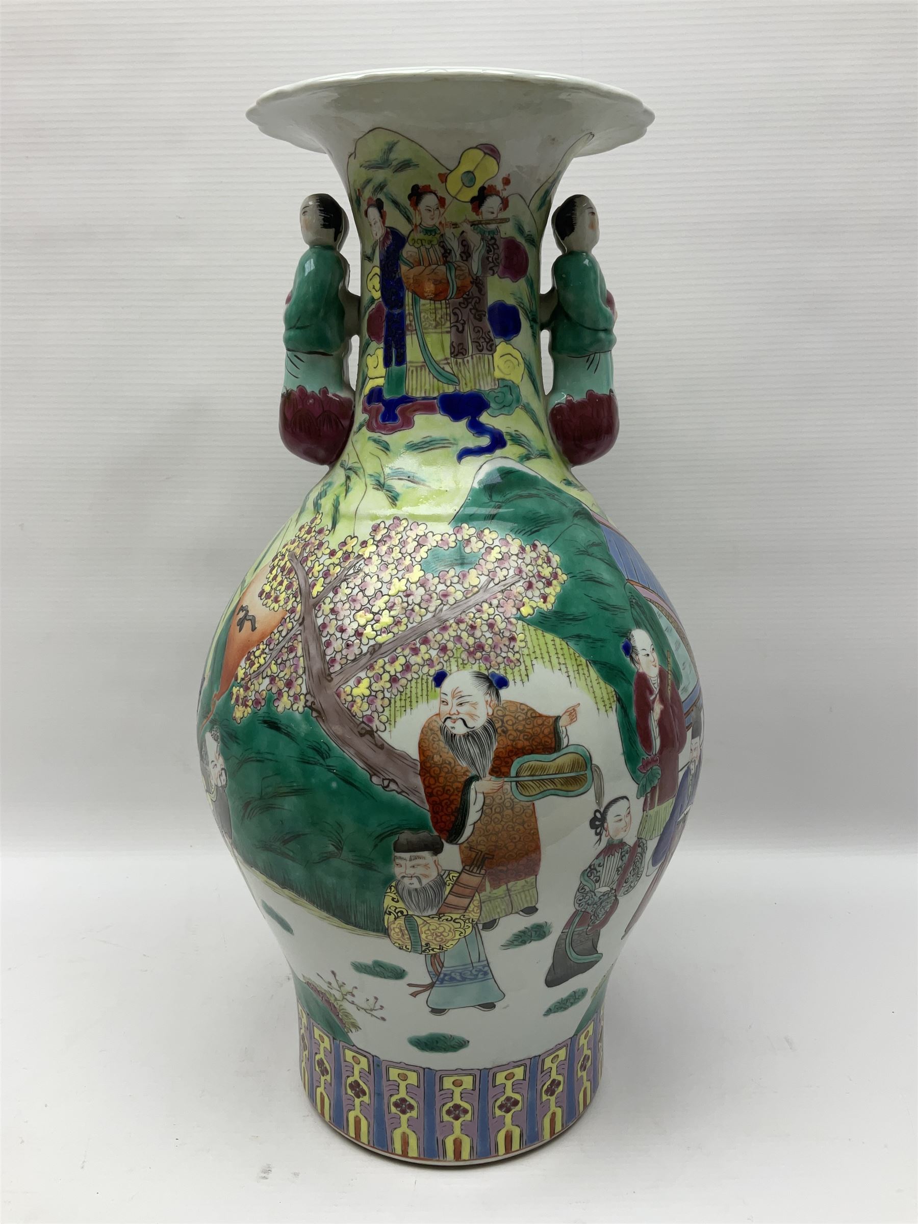 20th century Chinese Famille Rose vase, of baluster form with flared lobed rim and twin figural handles, decorated in polychrome enamel with figures dancing and playing instruments within a garden setting, H42cm