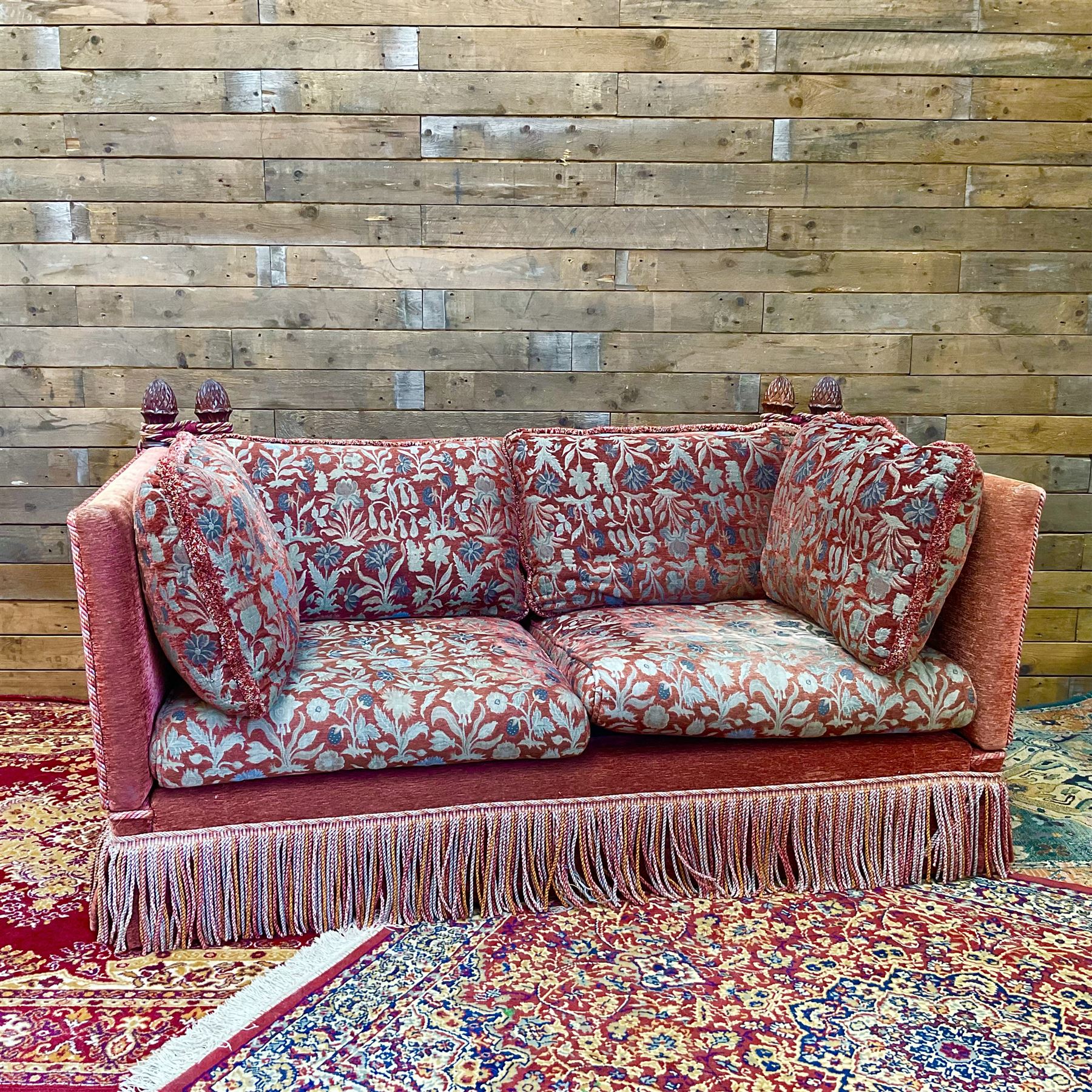 Knole type drop arm sofa with cushions in a traditional patterned upholstery,