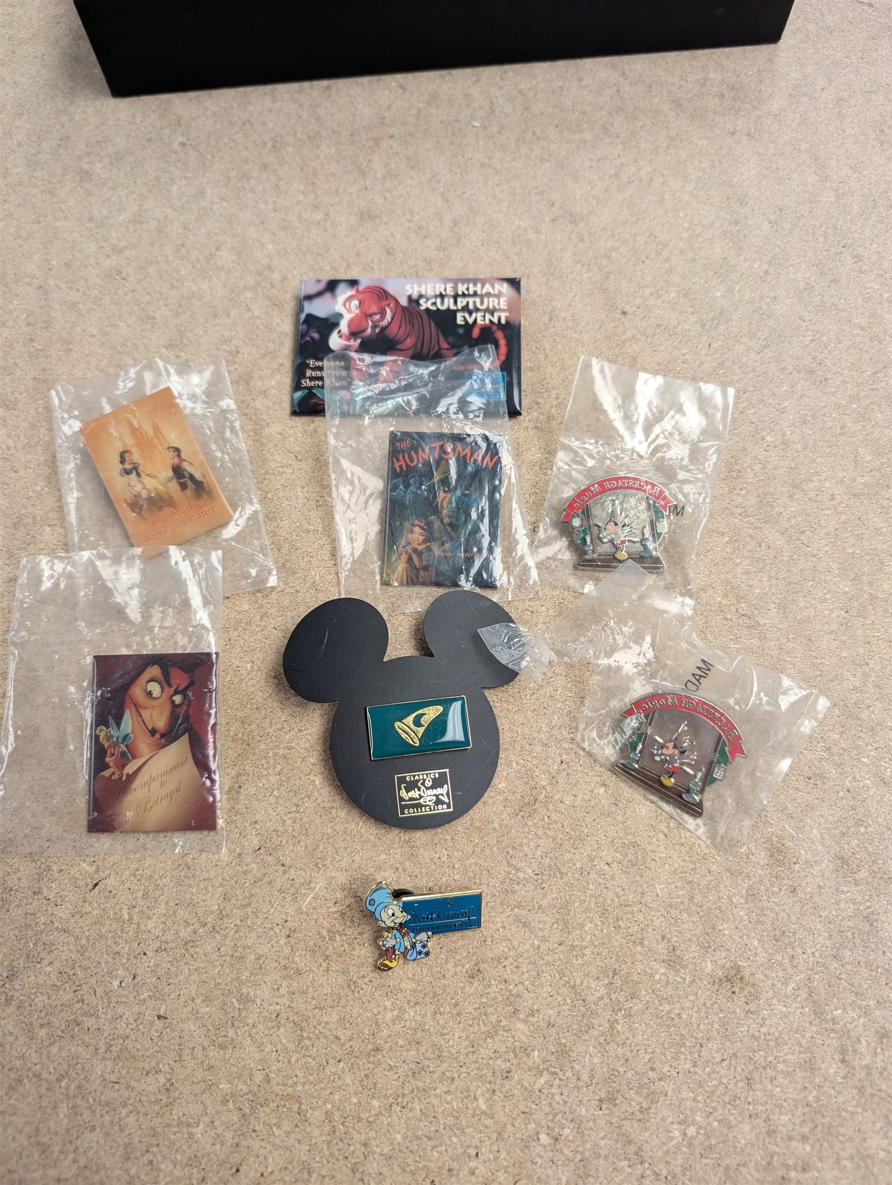 Collection of Disney memorabilia and ephemera, including Walt Disney Treasures DVD, two Disney Villains mugs, enamel pins, Mickey Mouse D23 fan club pack, Disney Twenty-Three magazines, Sketches magazines, etc