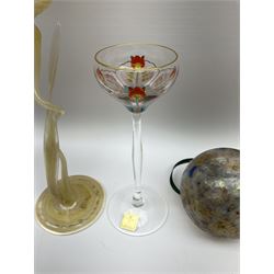 Two early 20th century Theresienthal enamelled liqueur glasses, the shallow coup bowls decorated with  colourful floral design and edged with gilt raised upon slim tapering stems with circular spreading foot, together with an art glass flower in the style of Karl Kopping with curving stem and leaf signed indistinctly Rachel (Kustall Franenam?) and two further art glass balls