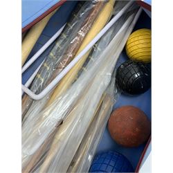 A croquet set, with wooden mallets, hoops, and balls, in carry bag. 