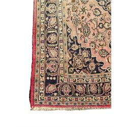 Persian Kashan carpet, blue shaped medallions and spandrels, the field decorated with interlacing branch and stylised plant motifs, repeating floral design borders