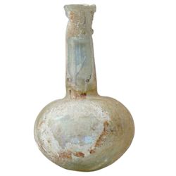 Three Roman glass funerary vessels c. 1st-3rd century AD, comprising a group of free-blown glass vessels: two unguentaria with elongated necks and rounded bases, and one squat lachrymatory or tear bottle, heights: 7.5cm, 6.5cm and 5cm
Notes: Unguentaria held oils/perfumes; small bottles of this type are traditionally described as ‘lachrymatories’, though their practical use is generally associated with unguents
Provenance: By the vendor’s repute, acquired/collected in the Middle East (Dead Sea area/Syria) in the 1960s